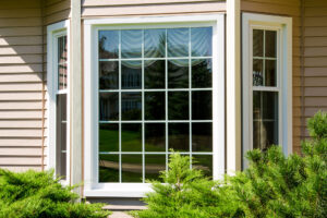 A bay window on a home with beige siding.
