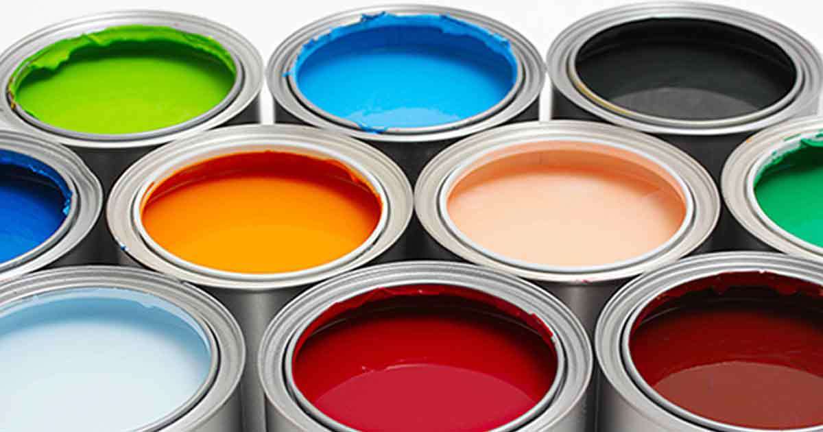 Multiple cans of paint with the lids off showing their various colors.