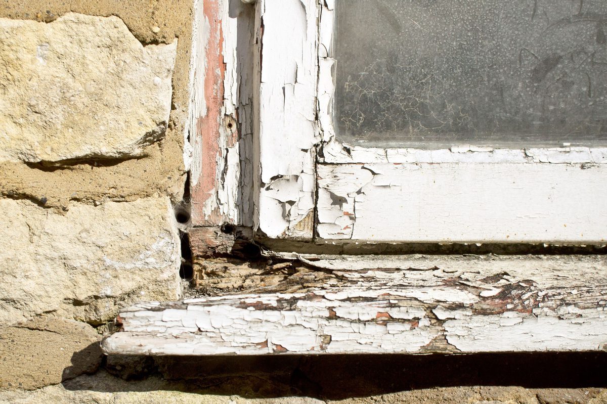 A close up of a rotting wood frame.