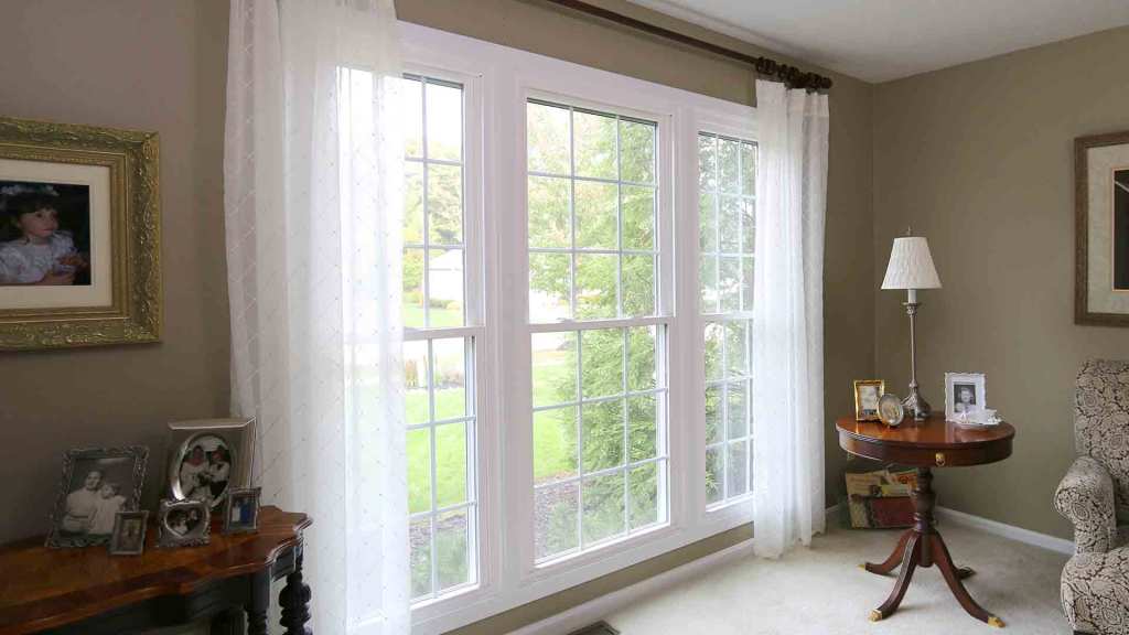 White double-hung replacement windows on a brick home