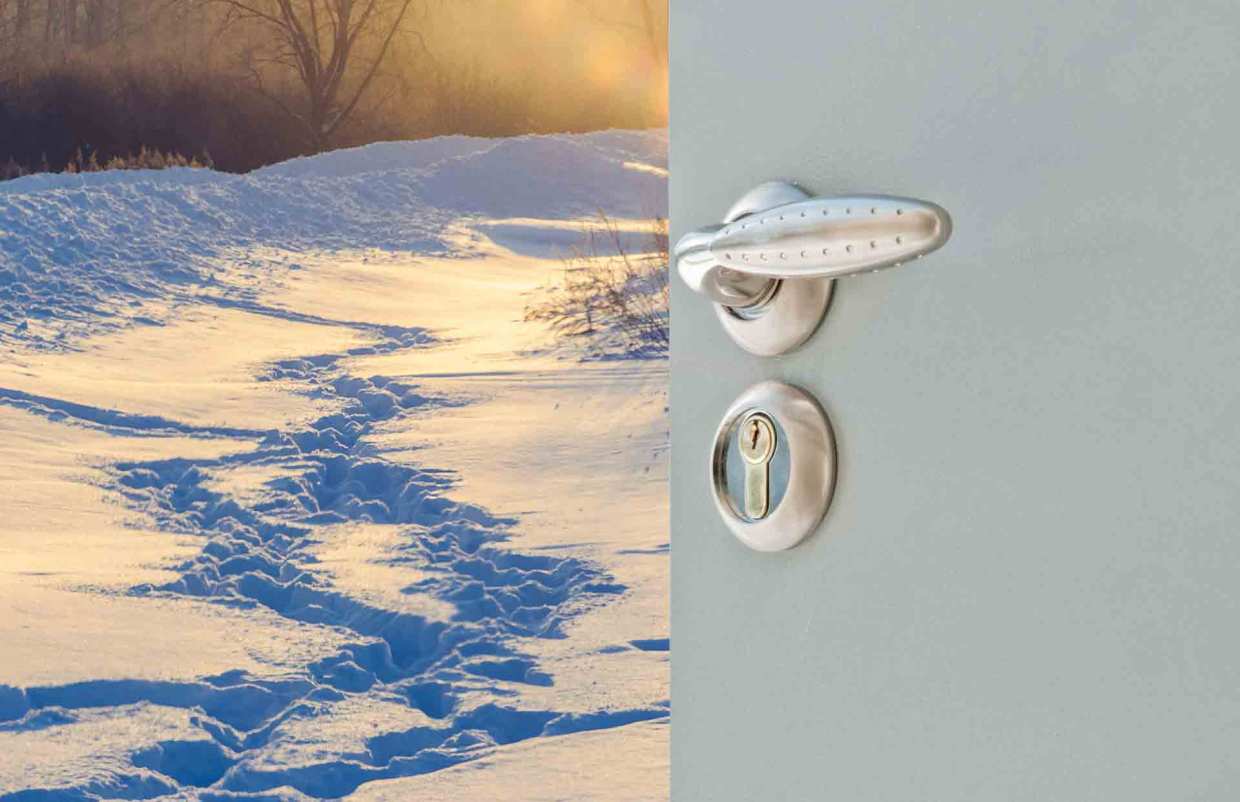 An entry door opens to reveal a field of deep snow.