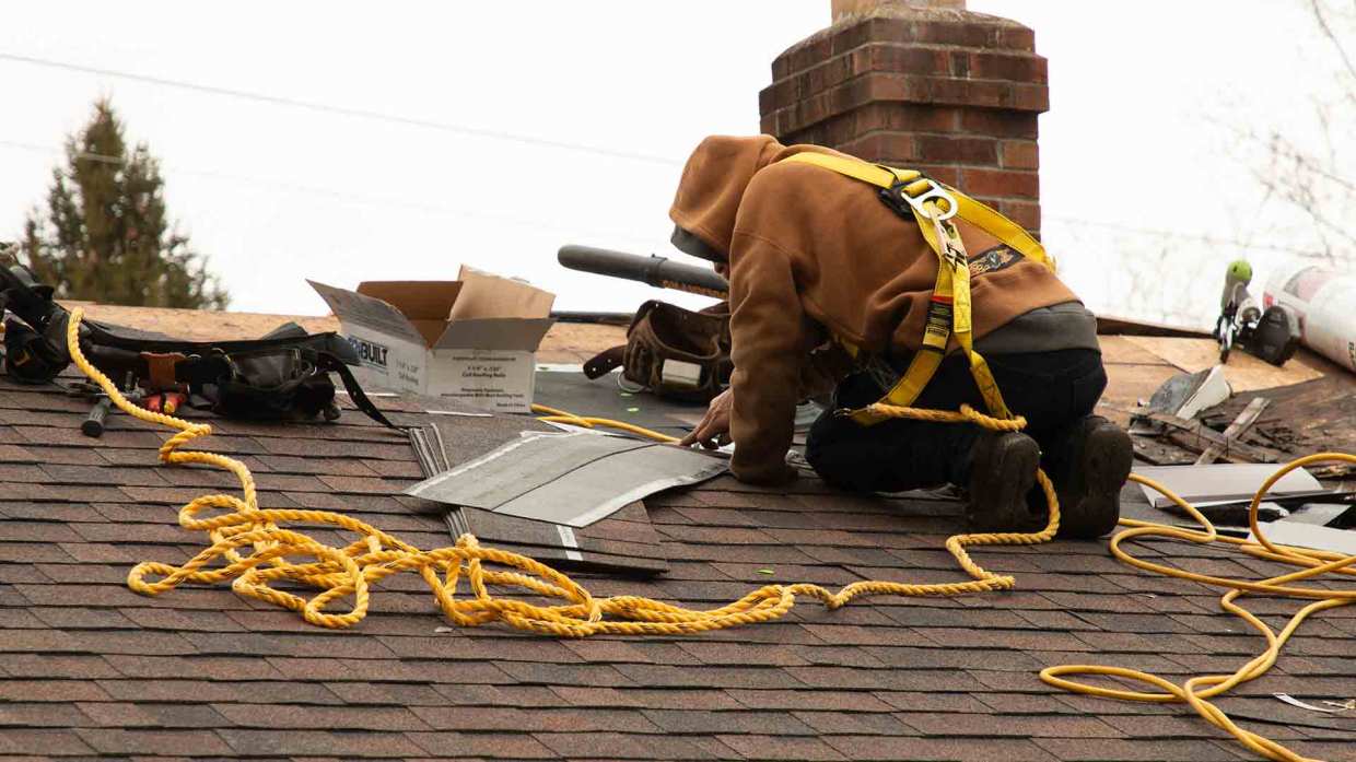 A Universal Windows Direct installer works on a roof replacement job.