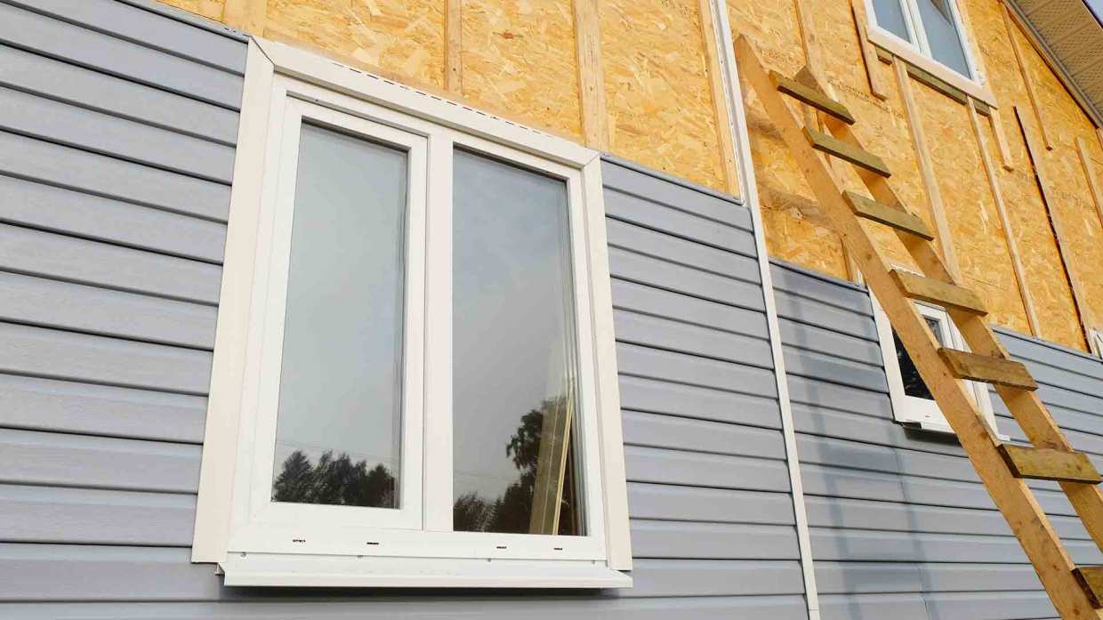 A home that's in process of getting new siding installed.
