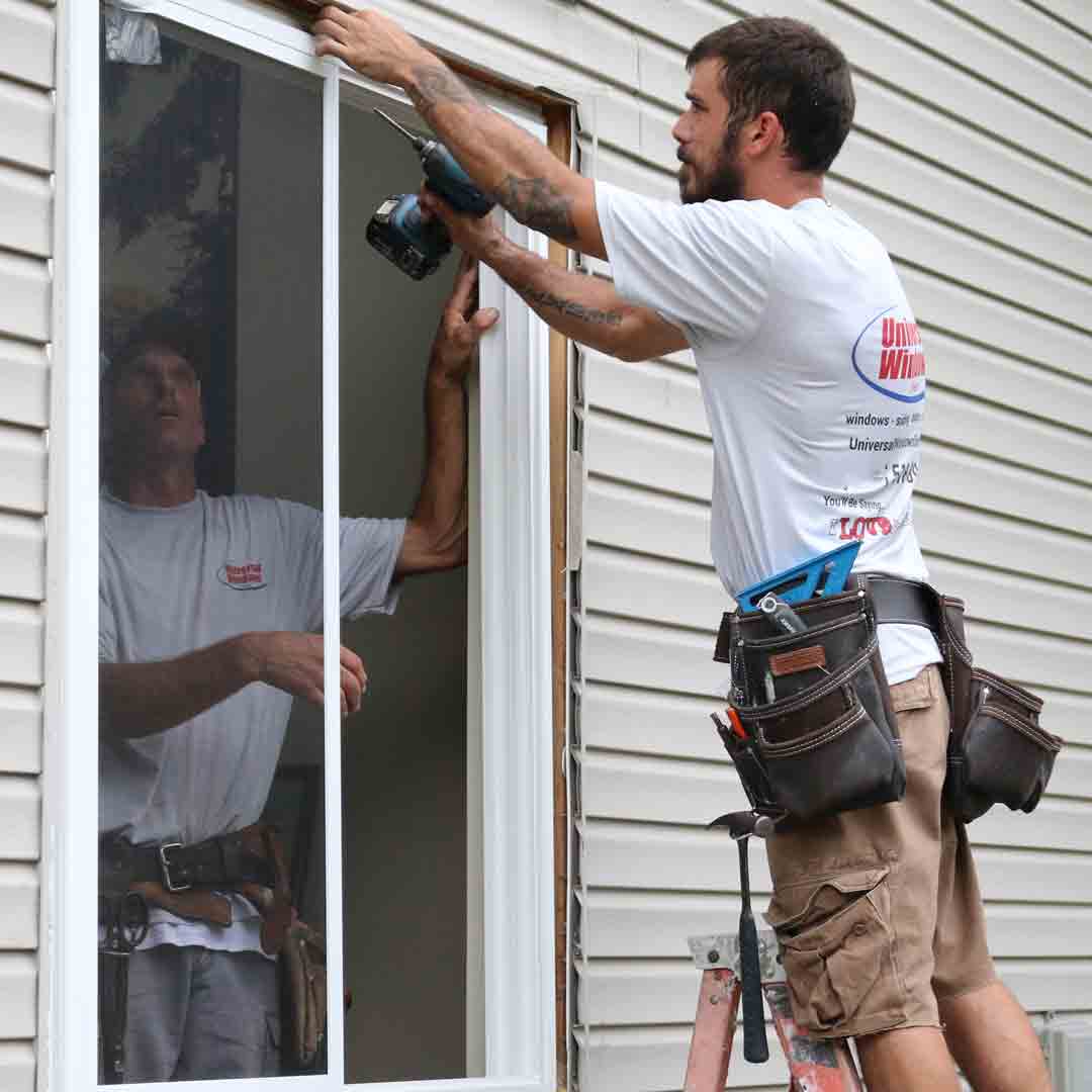 Installer Installing Sliding Glass Window installer drilling in window