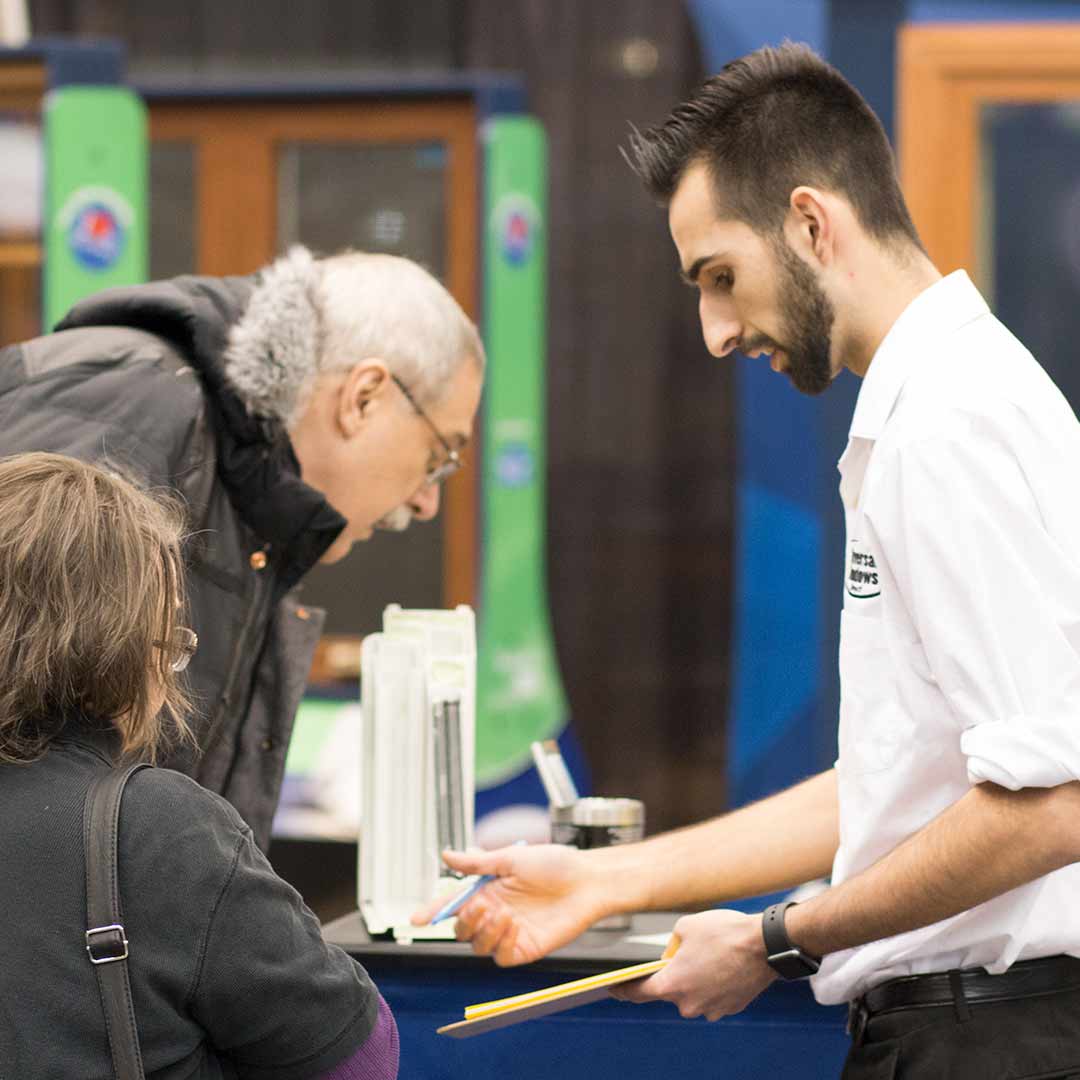 UWD Marketer with Customers UWD marketer discusses products with customers at home and garden show