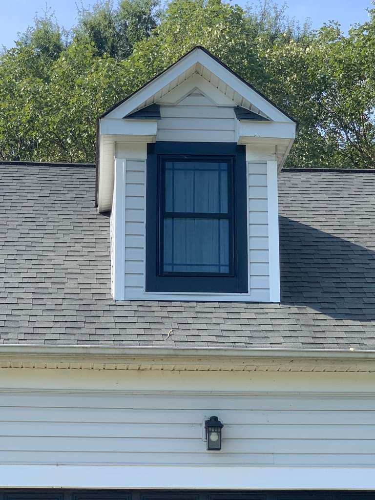 A close up for a black window installed by Universal Windows Direct on a home's dormer.