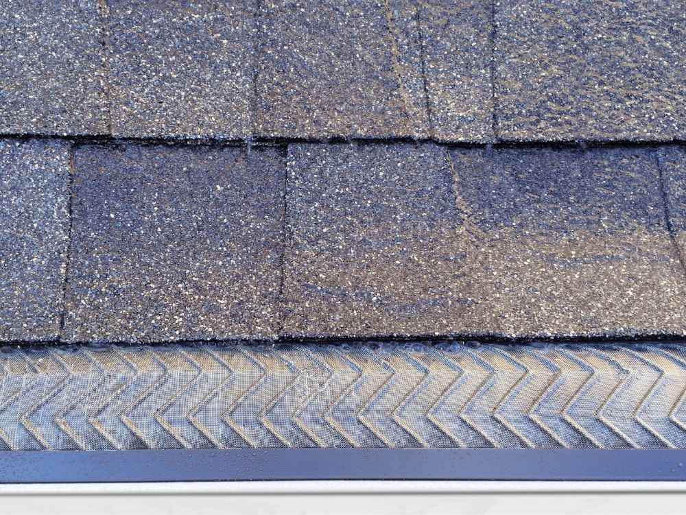 A birds-eye-view of the edge of a roof to see the gutter guard from above - installed by Universal Windows Direct.