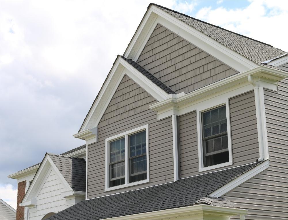 A gray house with shakes and horizontal siding installed by Universal Windows Direct.