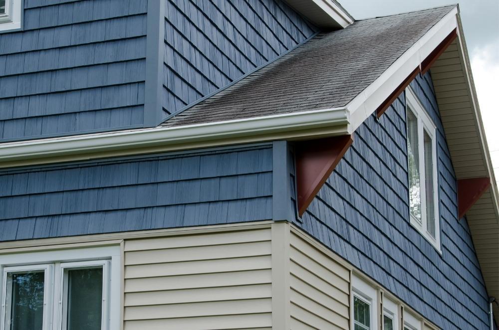 A house with blue shakes siding at the top and taupe horizonal siding at the bottom installed by Universal Windows Direct.