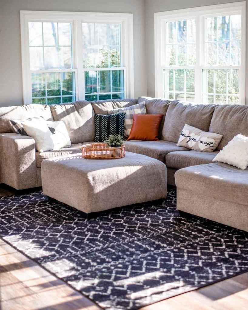 A bright, sunlit living room with white windows installed by Universal Windows Direct.