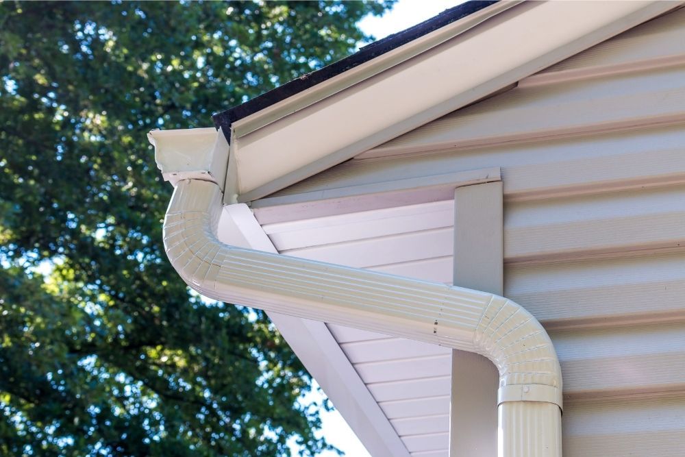 Side view of gutter end cap and gutter elbow installed by Universal Windows Direct.