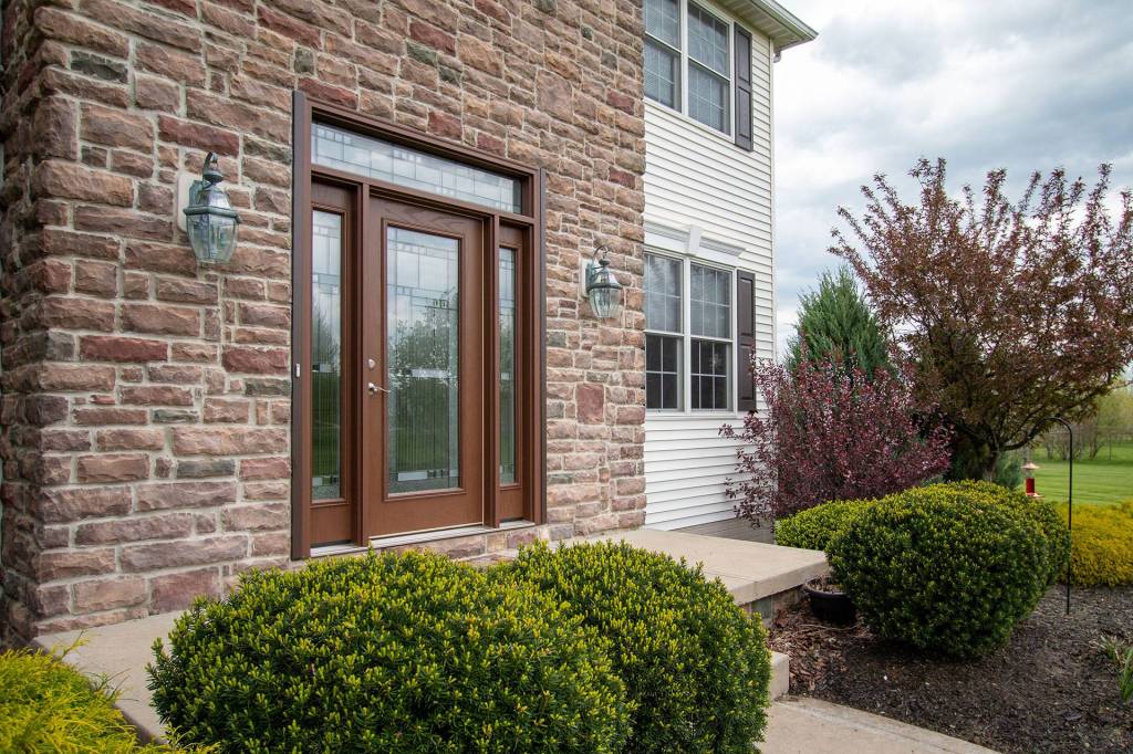 Fiberglass entry door with decorative glass sidelites and transom