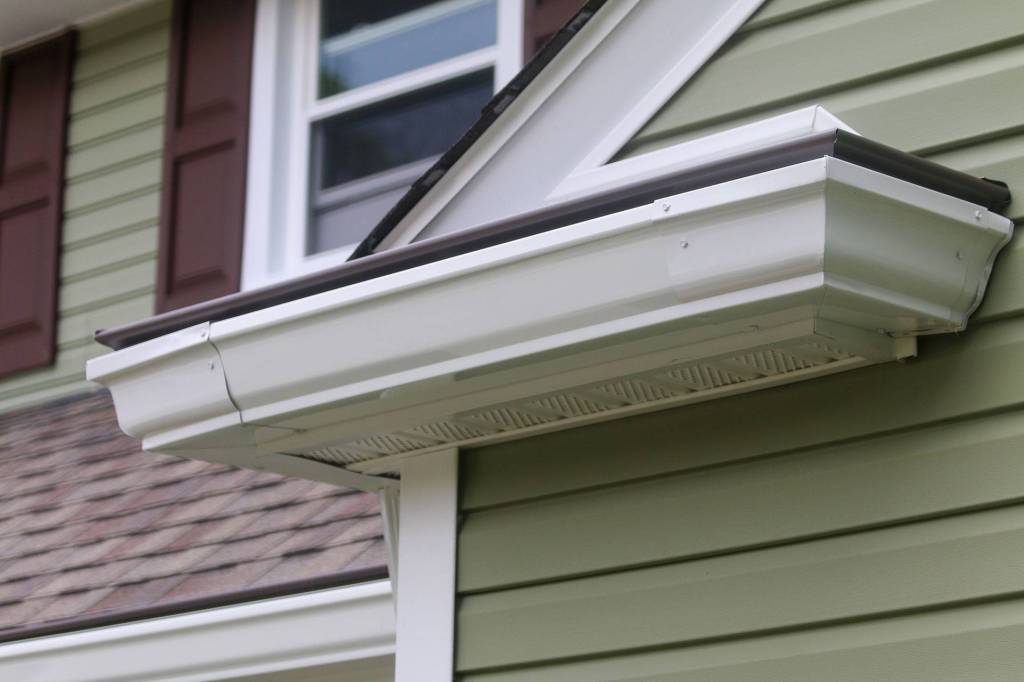 New seamless gutter and vented soffit at a roof corner