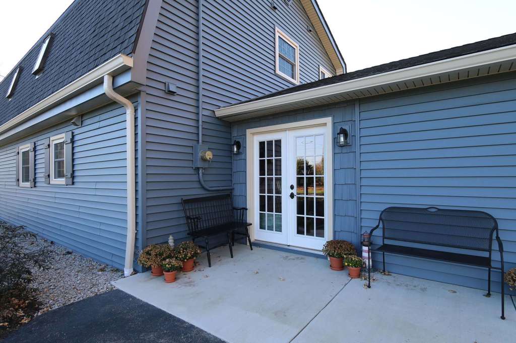 White French patio doors on a blue-sided home