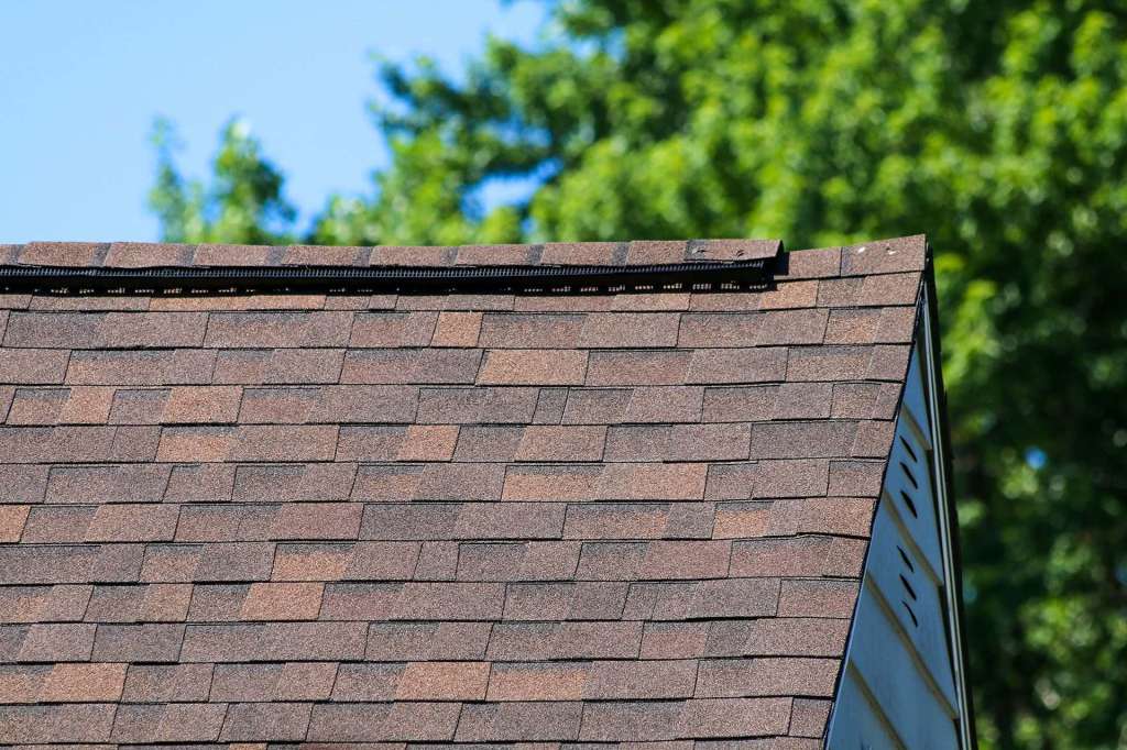 Roof peak with new architectural shingles and ridge vent
