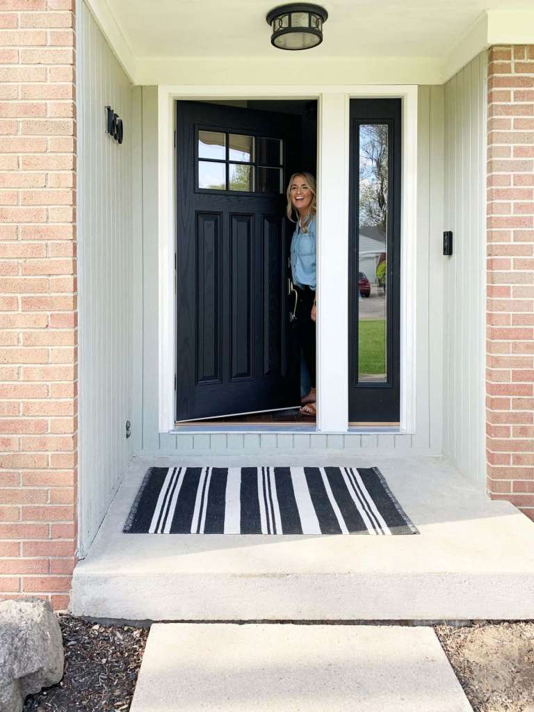 Black craftsman-style entry door with a full-glass sidelite