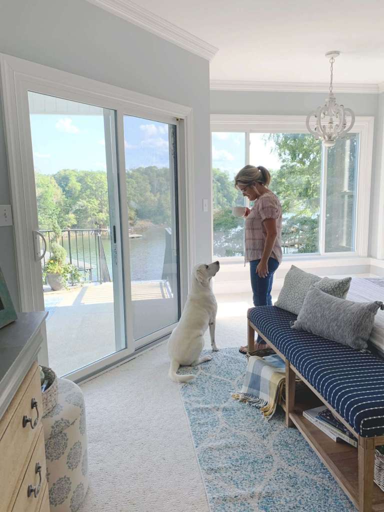 Sliding patio door brightening a lakeside bedroom