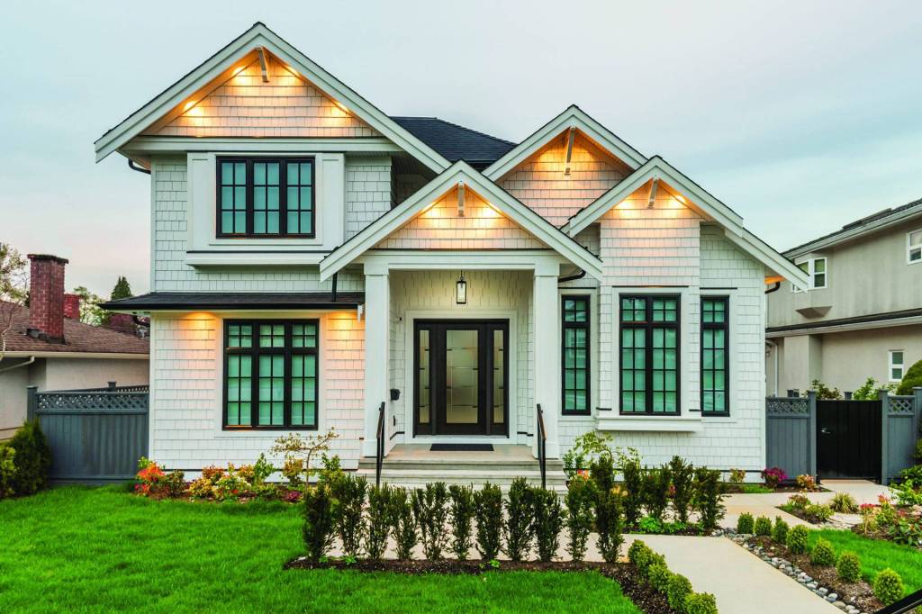 Craftsman-style home with black-framed windows and a decorative glass entry door