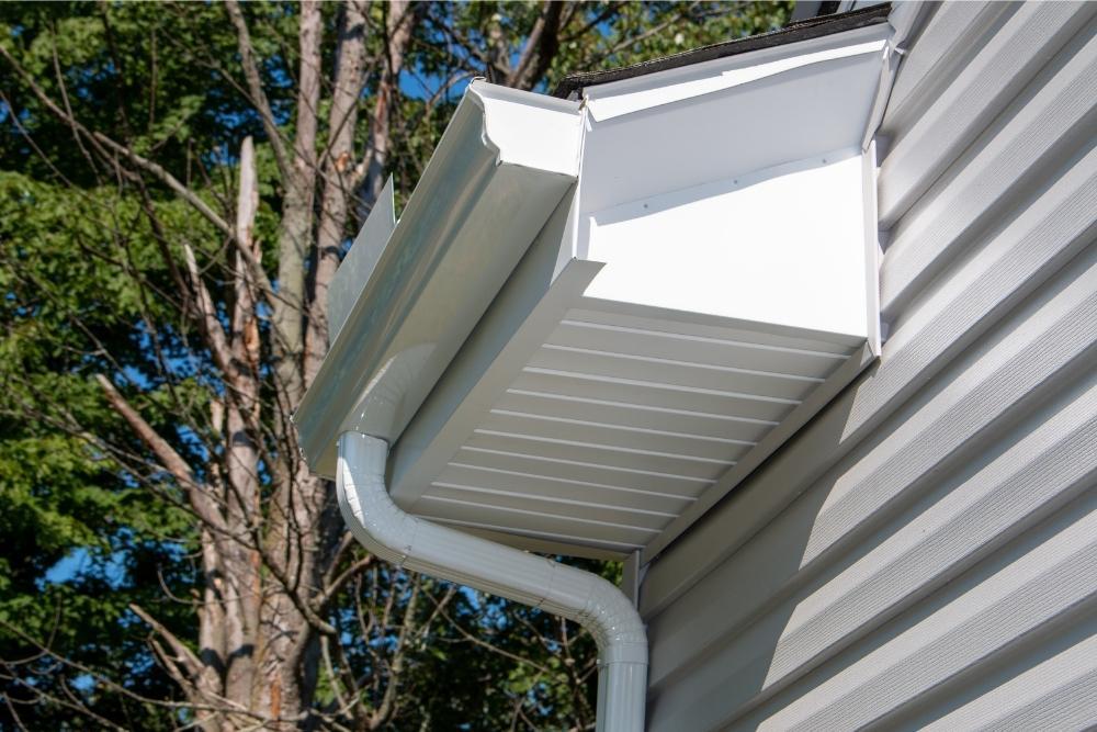 Underside view of a gutter with splash guard and gutter elbow installed by Universal Windows Direct.
