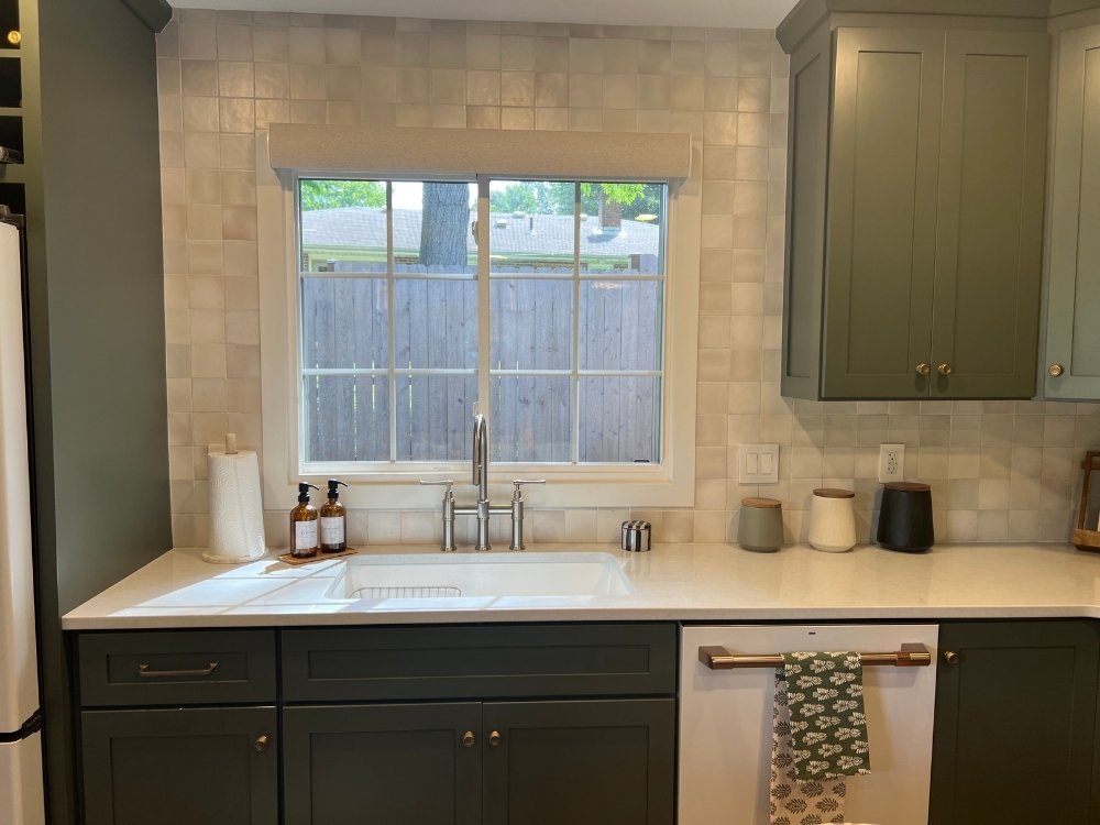 A while gridded window installed by Universal Windows Direct hangs above the kitchen sink.