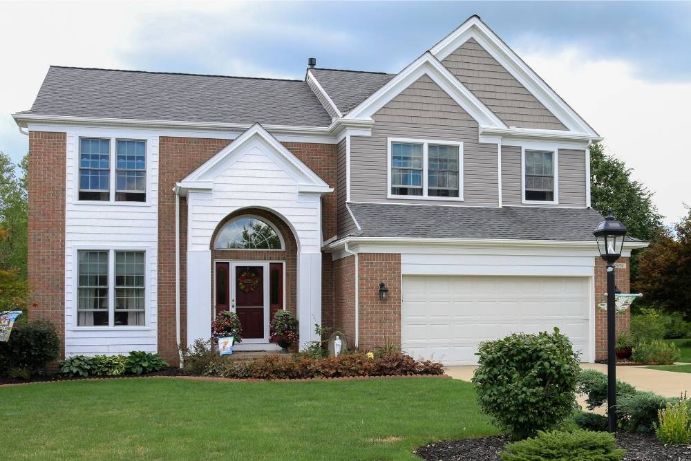 Curb-side view of the front of an entire house with windows installed by Universal Windows Direct.