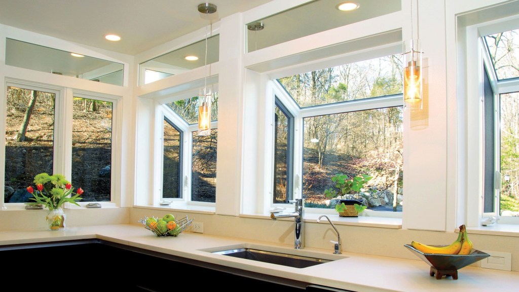 Garden windows line the kitchen wall above the sink and counter.