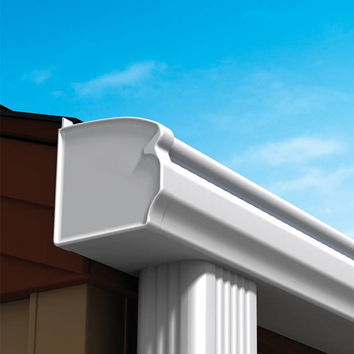 Close-up of a white seamless gutter along a roof edge
