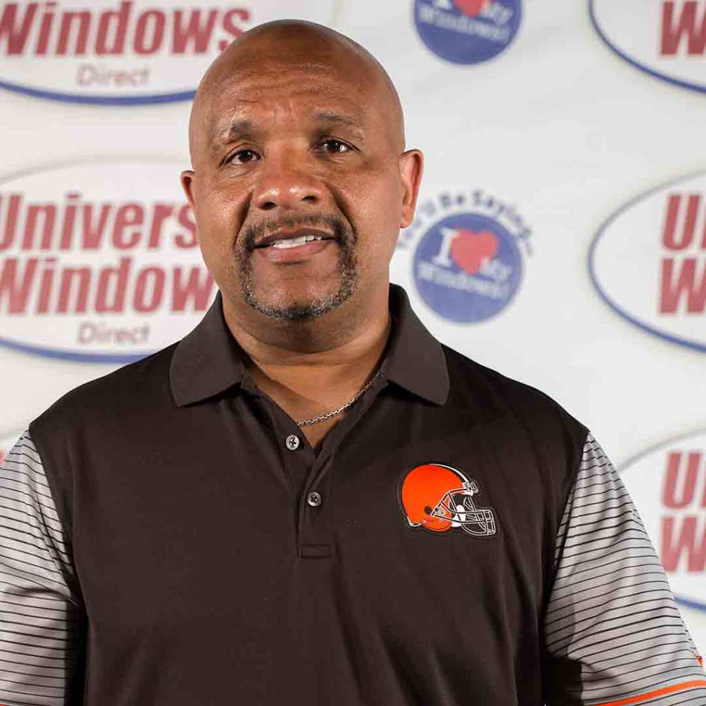 Browns head coach Hue Jackson in a team polo in front of a Universal Windows Direct backdrop