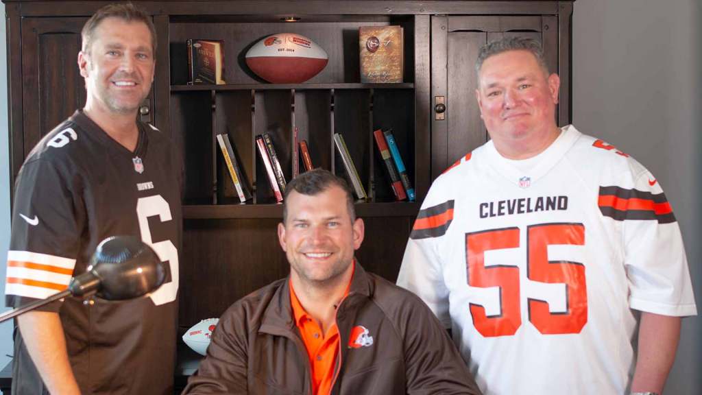 Two Universal Windows Direct staff members in Browns gear with lineman Joe Thomas in his number 55 jersey
