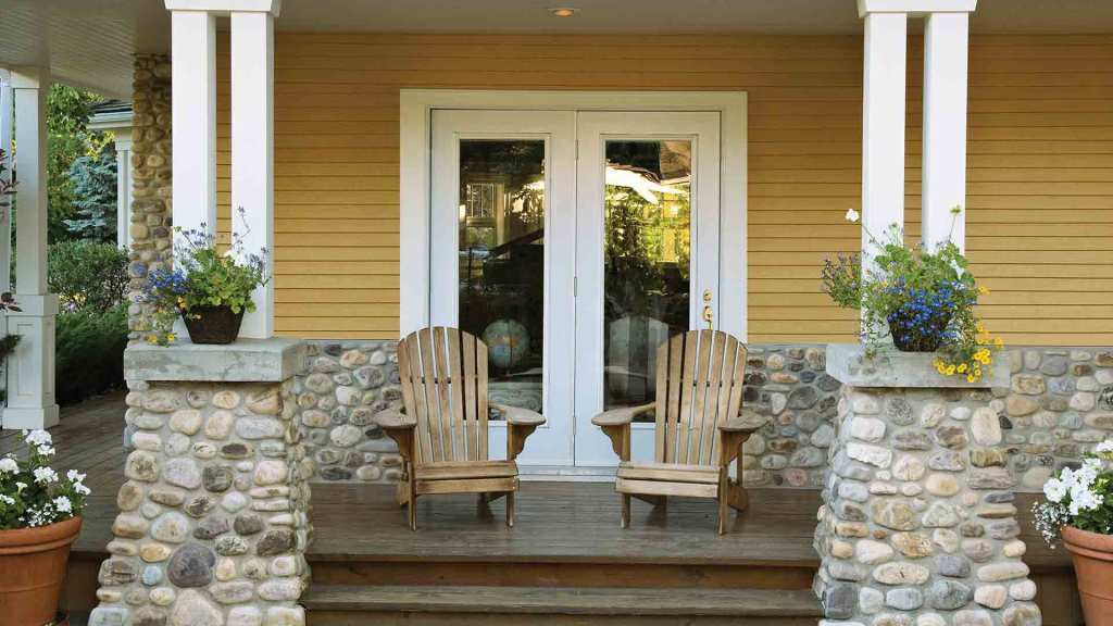 Porch with white French patio doors and Adirondack chairs