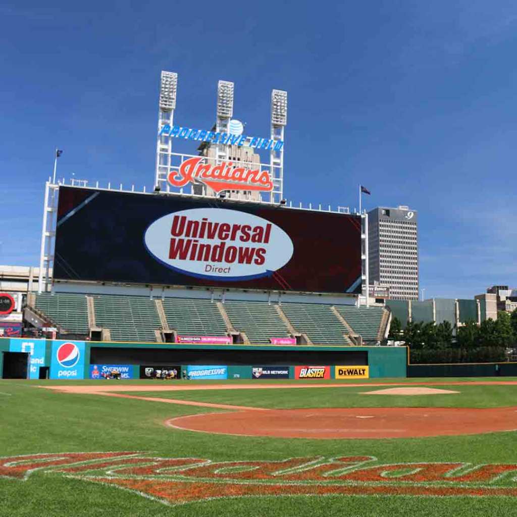 Progressive Field with a Universal Windows Direct ad on the scoreboard above an empty ballpark