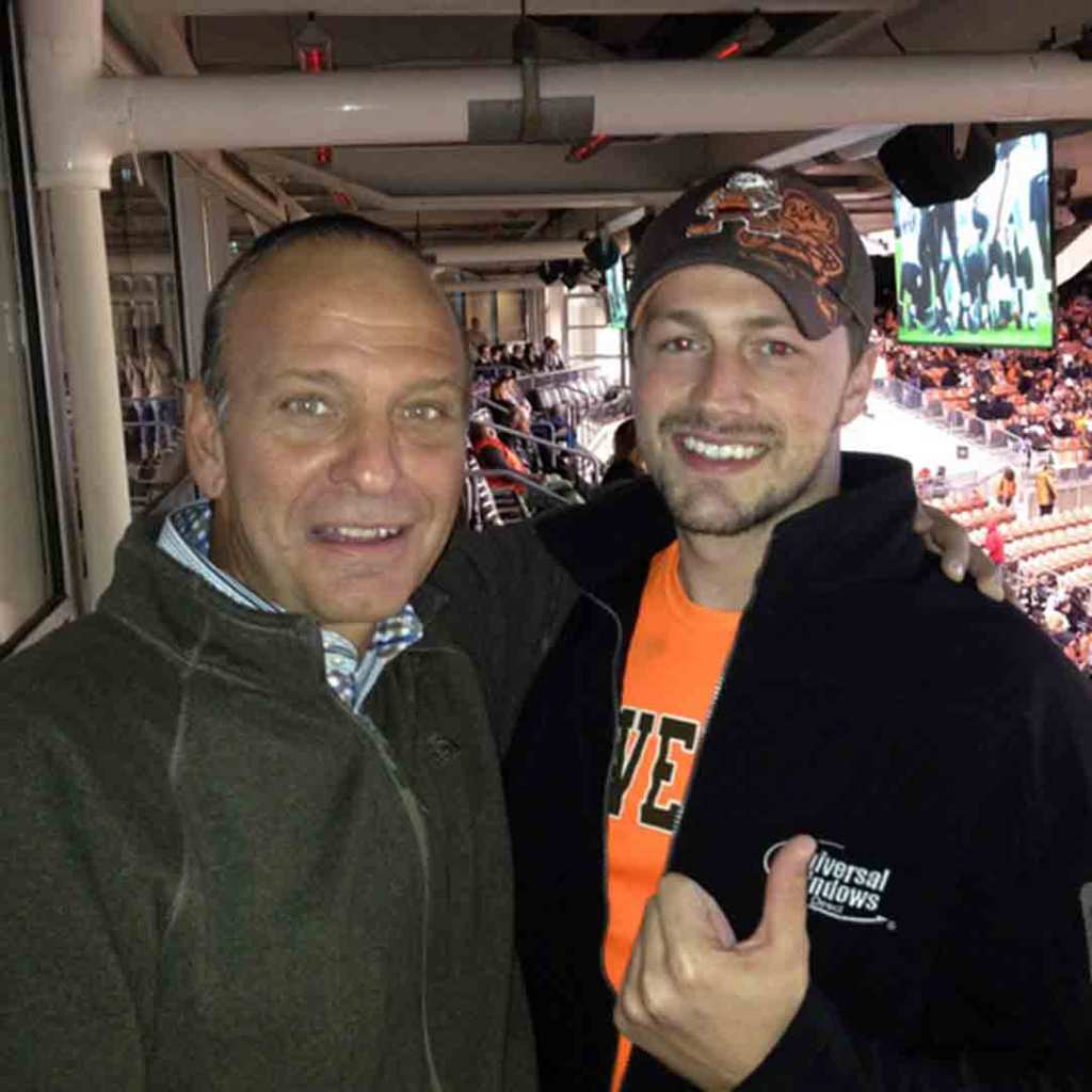 Cleveland radio personality Tony Rizzo with a Universal Windows Direct representative at a Browns game