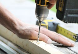 UWD installer fitting a replacement window from inside the home